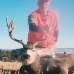 hunter holding a mule deer